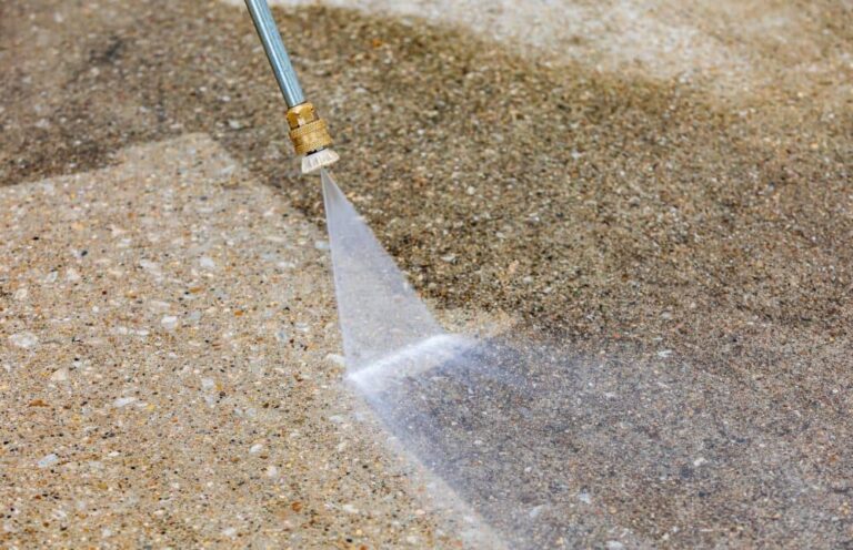Cleaning driveway using power washer